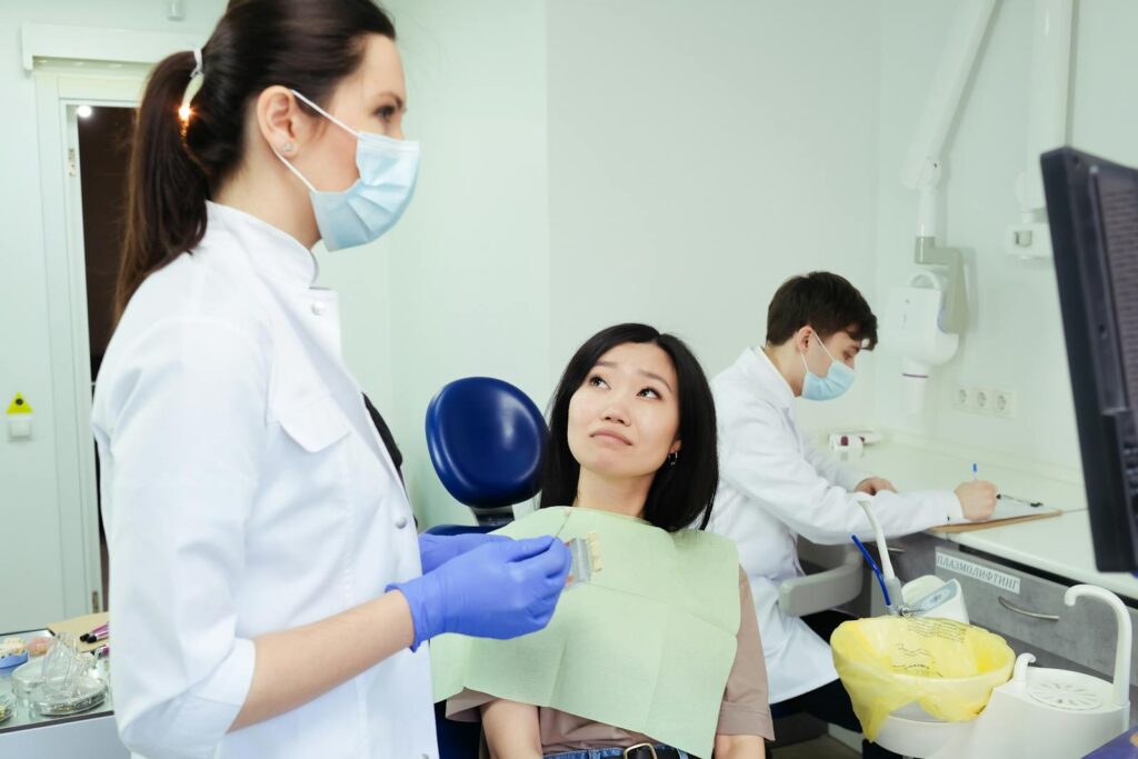 A Woman Sitting on Blue Dental Chair